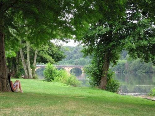 Jenny writing the diary beside the Dordogne, Trémolat Walking in France Diaries and Maps