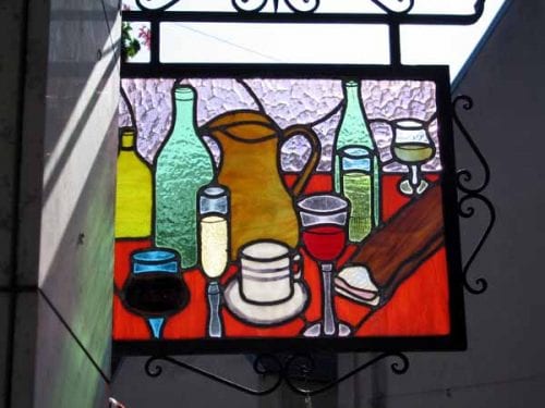 Walking in France: The stained-glass sign hanging outside a bar