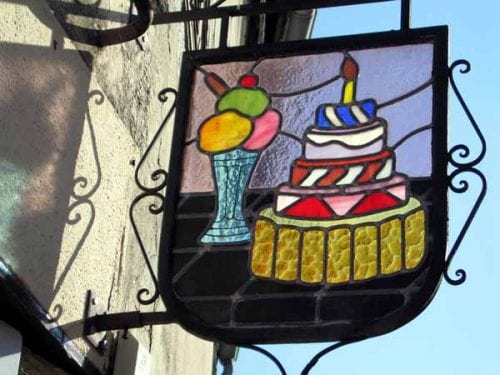 Walking in France: The stained-glass sign outside the cake shop
