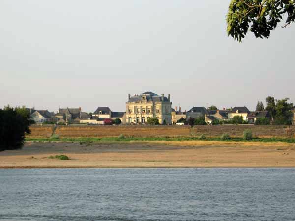 Walking in France: Les Rosiers, behind its levee bank, across the Loire from the camping ground