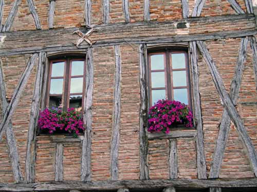 Walking in France: Flower window boxes in the main square, Castelnau-de-Montmiral
