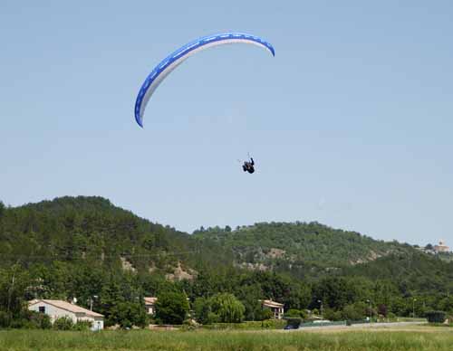 Walking in France: A paraglider about to land at the camping ground