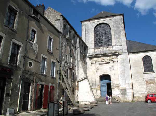 Walking in France: Inside the abbey portal, with decrepit modern buildings