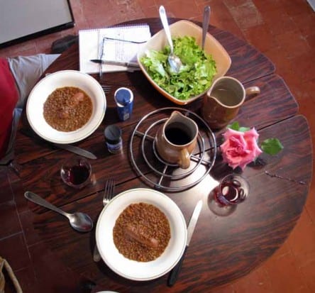 Walking in France: The dinner table - lentils, a sausage, salad from François, red wine and a rose