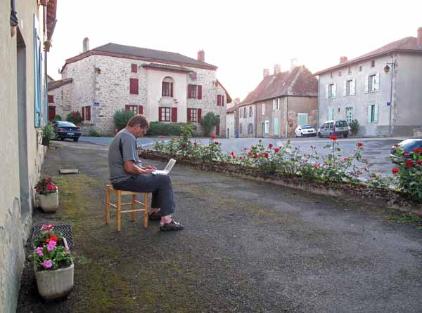 Walking in France: A pilgrim using the internet outside a gîte