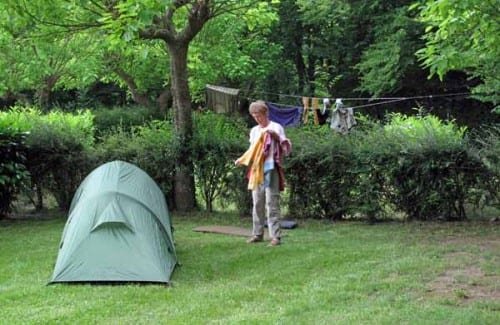 Walking in France: Jenny bringing in her washing, Saint-Astier camping ground