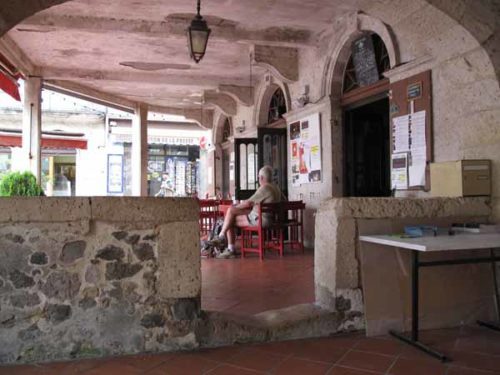 Walking in France: Coffee in an arcade with the worn step, Mézin