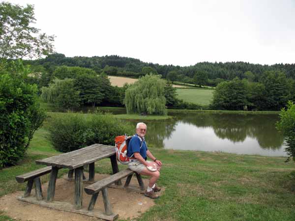 Walking in France: Pondering what to do next, beside the lake at the Propières camping ground