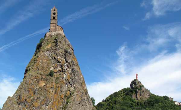 Walking in France: The Chapel of Saint-Michel-d'Aiguilhe on the near puy, with the red statue of the Virgin in the distance