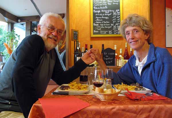 Walking in France: Two happy, warm walkers having dinner