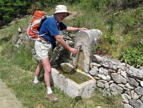Walking in France: Filling up at a stone water trough 