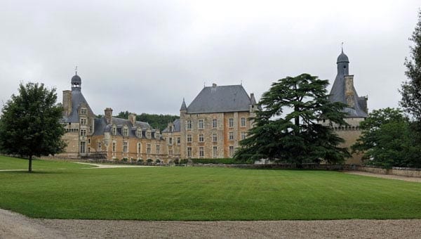 Walking in France: The view of Château de Touffou through locked gates