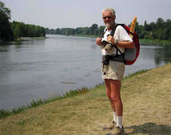 Walking in France: Walker with baguette, beside the Loire near Saint-Ay
