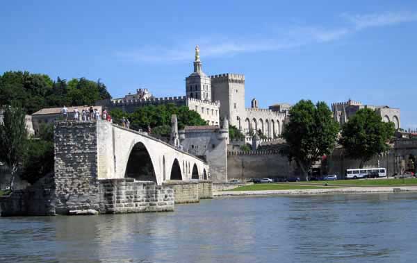 Walking in France: Pont Saint-Bénezet, also known as the Pont d'Avignon, with the Palace of the Popes in the background