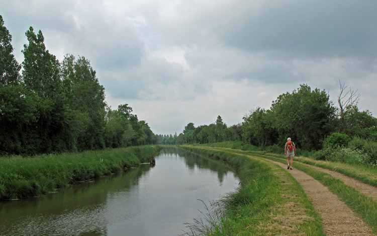 Walking in France: On the towpath with ominous clouds in the distance
