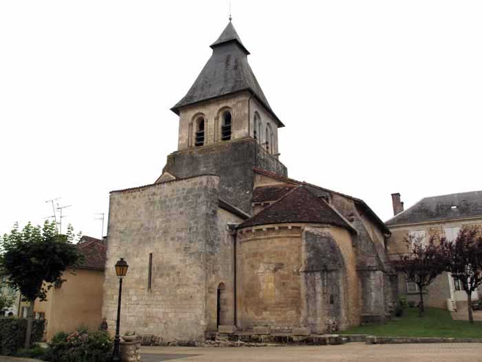 Walking in France: The eastern end of the Sorges church with a heavy defensive wall and slit