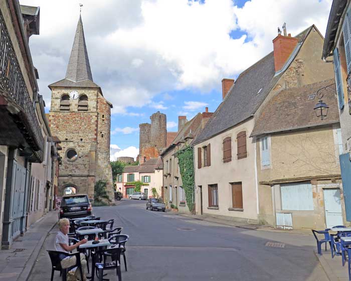 Walking in France: A rosé, with the lonely bell tower behind, and a glimpse ruined of the castle further away, Hérisson