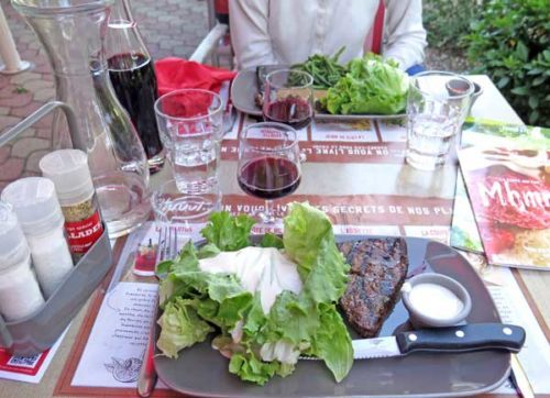 Walking in France: Our mains, faux filet with salad, beans, and Roquefort sauce for Keith