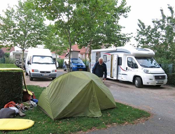 Walking in France: Just enough grass for our tent at the Aire de Camping Car, Montmarault