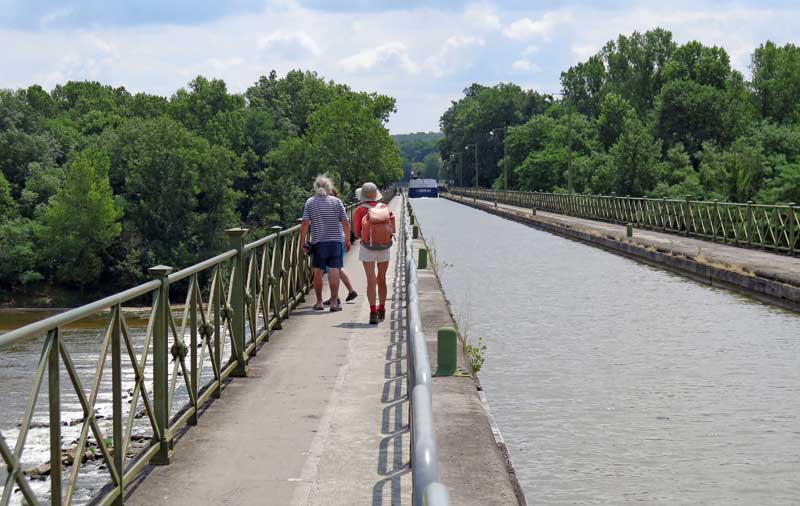 Walking in France: Our final crossing of the Allier, on the pont-canal, with a large boat in the distance