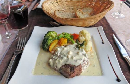 Walking in France: Our mains, a steak with a creamy sauce and a pile of colourful vegetables